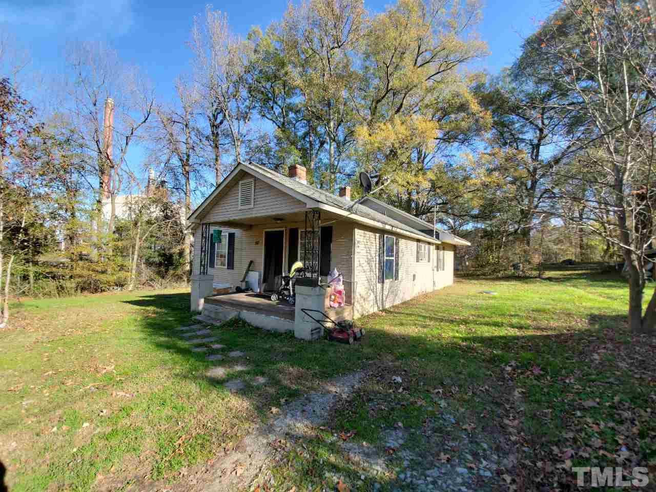 97 Allie Clay Road Roxboro, NC 27573 - Photo 1 of 20 a front view of a house with garden and trees