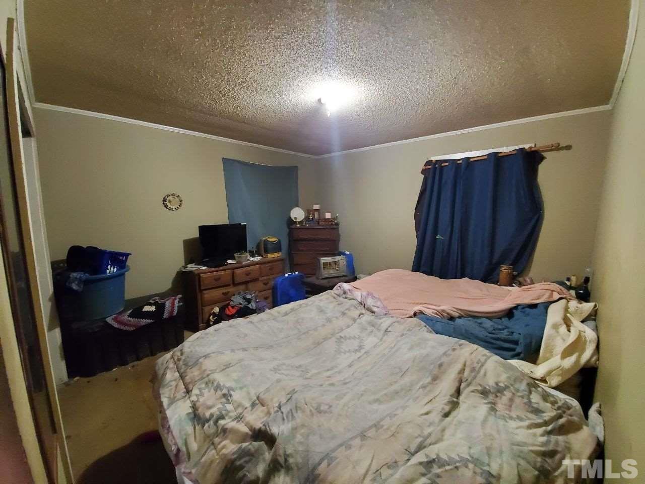 97 Allie Clay Road Roxboro, NC 27573 - Photo 14 of 20 a bed room with a bed
