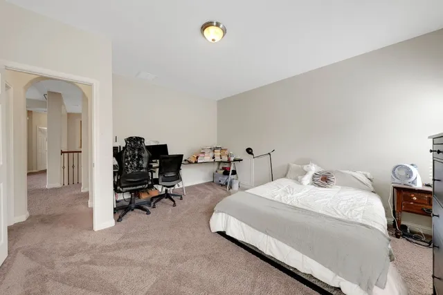 a bedroom with bed and a desk