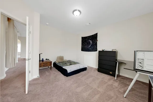 a living room with furniture and a lamp