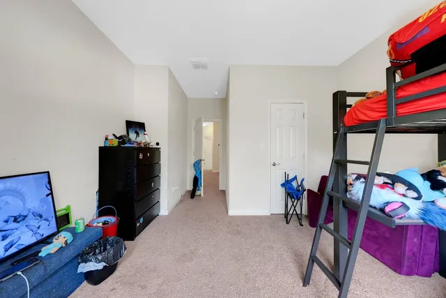 a bedroom with furniture and a closet