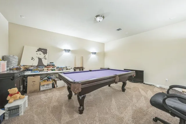 a room with furniture pool table and chair