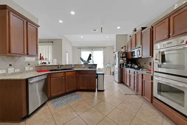 a kitchen with stainless steel appliances granite countertop a sink and cabinets