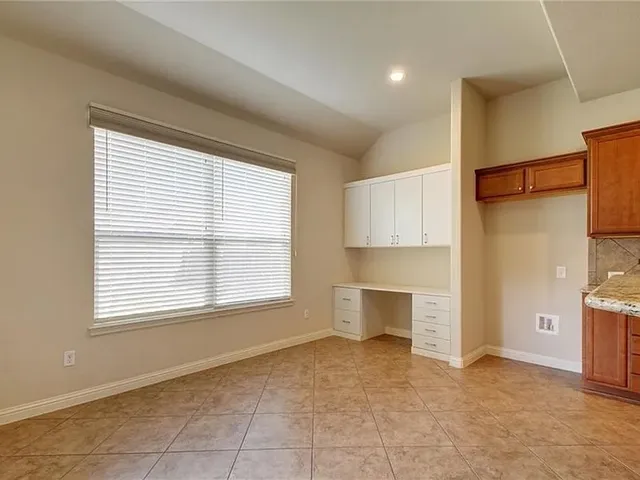 a view of a livingroom with a kitchen and a window