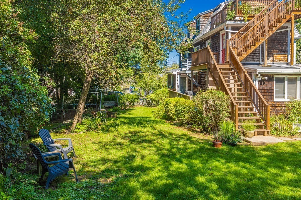28 Village Street, Unit 2 Marblehead, MA 01945 - Photo 2 of 16 a backyard of a house with table and chairs