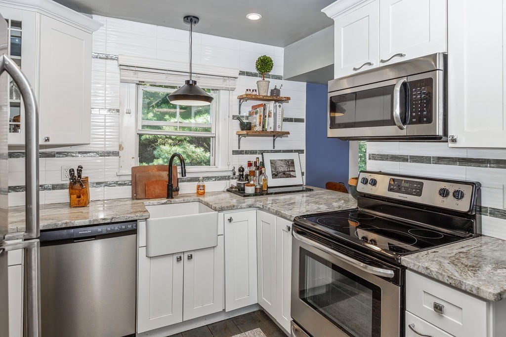 28 Village Street, Unit 2 Marblehead, MA 01945 - Photo 3 of 16 a kitchen with stainless steel appliances a stove a sink and a microwave
