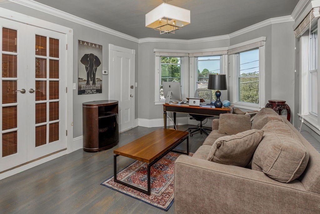 28 Village Street, Unit 2 Marblehead, MA 01945 - Photo 7 of 16 a living room with furniture a fireplace and a table