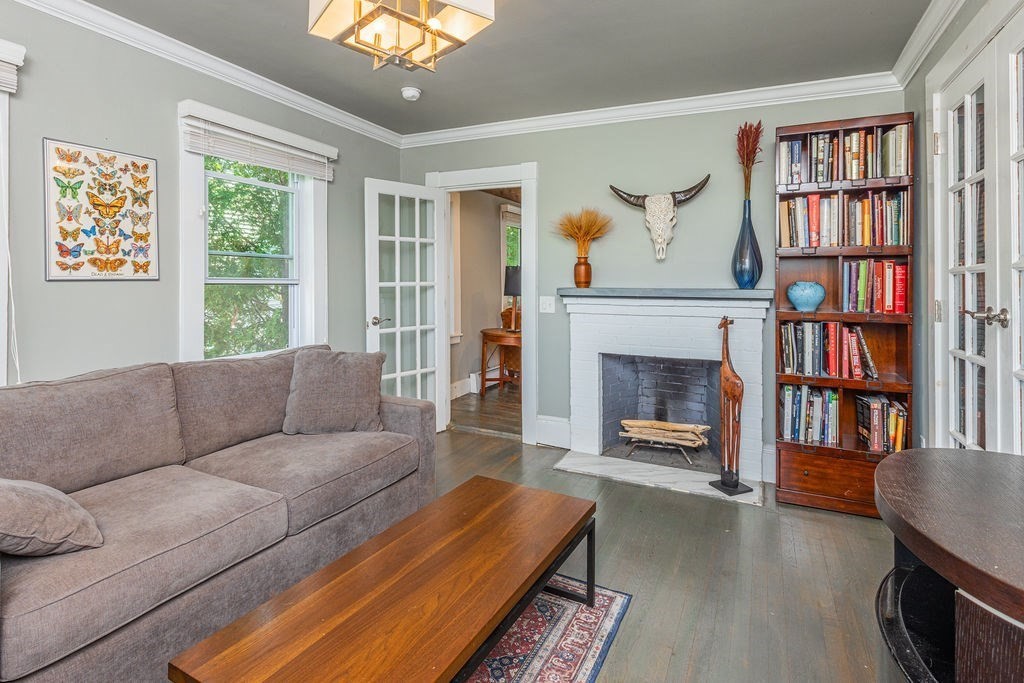 28 Village Street, Unit 2 Marblehead, MA 01945 - Photo 9 of 16 a living room with furniture a bookshelf and a fireplace