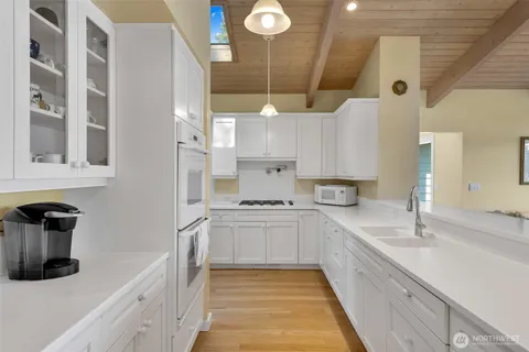 a kitchen with stainless steel appliances granite countertop a sink and a stove