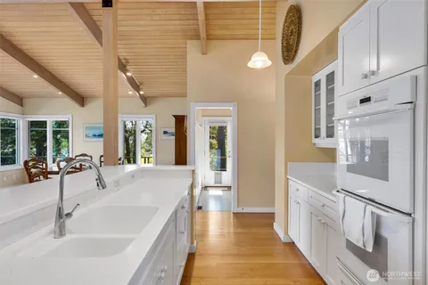 a large white kitchen with a large window