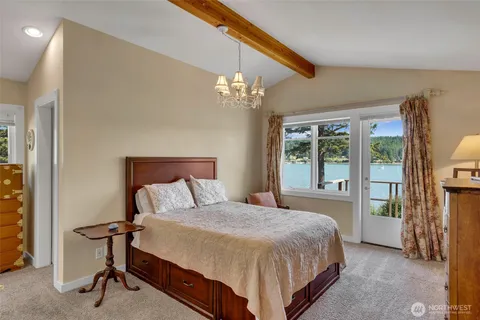 a bedroom with a large bed and a chandelier