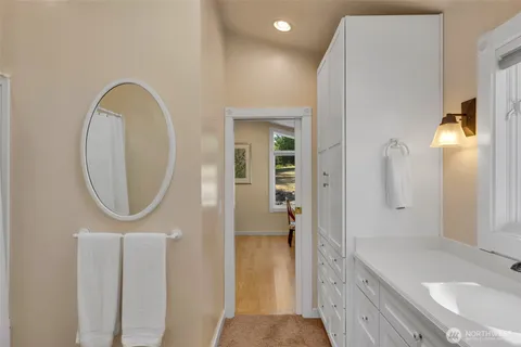 a bathroom with a sink a mirror and a shower