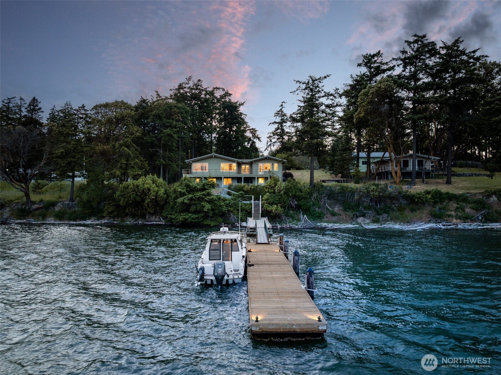 1794 Bayshore Road Lopez Island, WA 98261 - Photo 3 of 39 a wooden bench sitting next to a lake