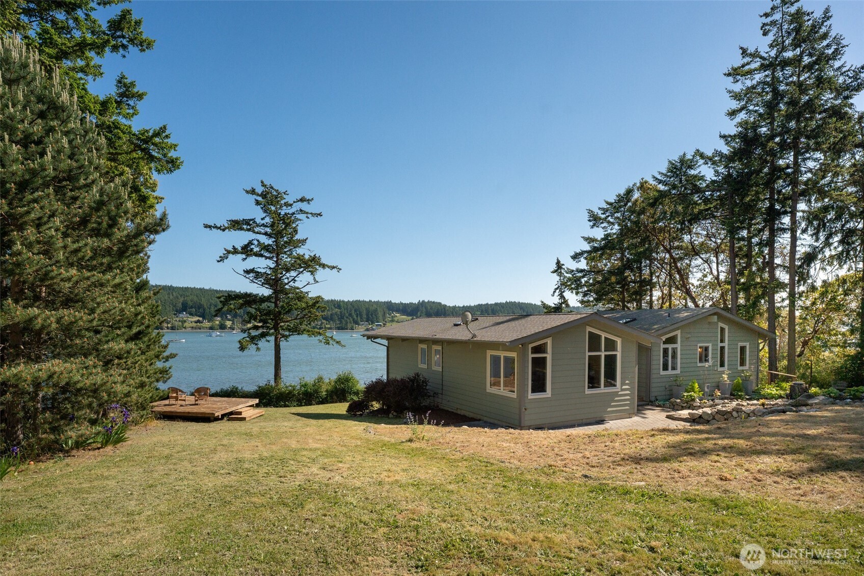 1794 Bayshore Road Lopez Island, WA 98261 - Photo 6 of 39 a front view of a house with a yard and garage