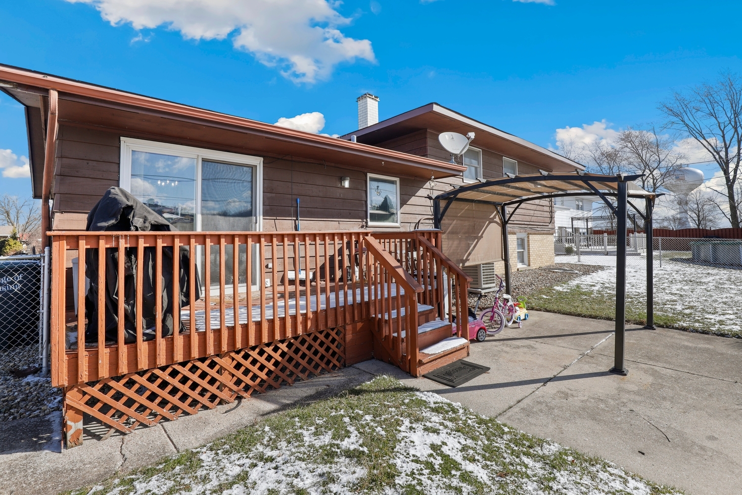 2951 193rd Street Lansing, IL 60438 - Photo 14 of 17 a view of a small house with wooden fence