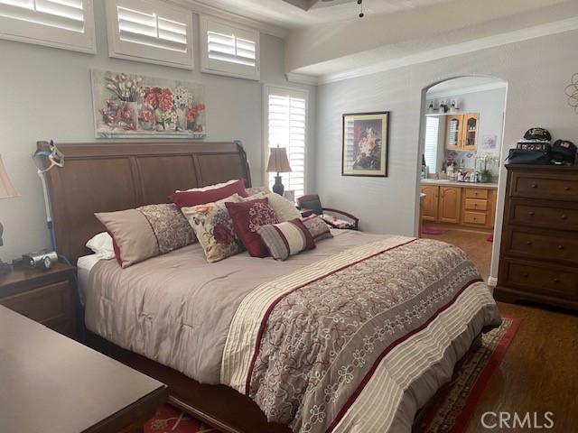 1051 Site Drive, Unit 281 Brea, CA 92821 - Photo 17 of 42 a bedroom with a bed and wooden floor