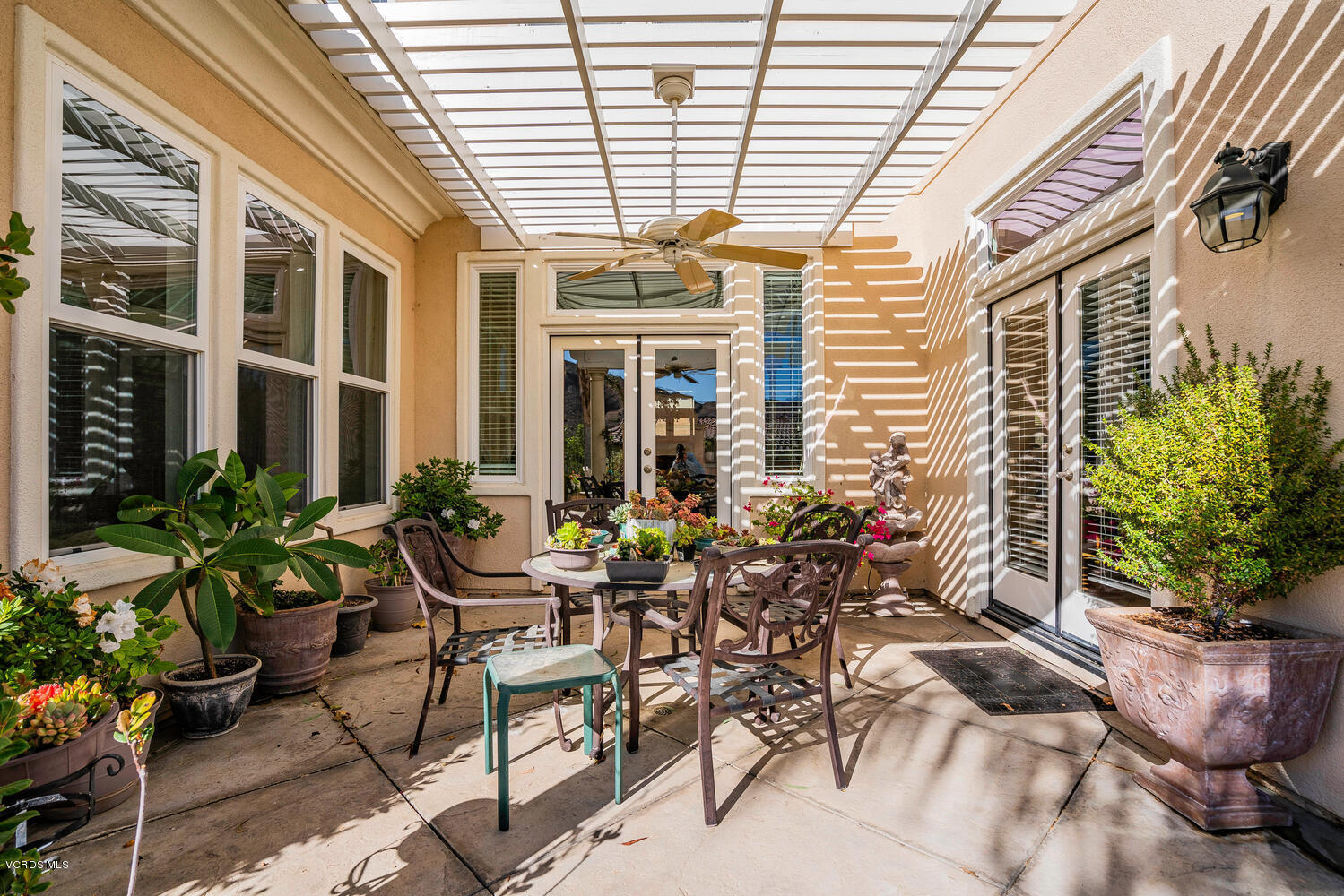 477 Vineyard Drive Simi Valley, CA 93065 - Photo 57 of 65 a view of a patio with plants and chairs and potted plants