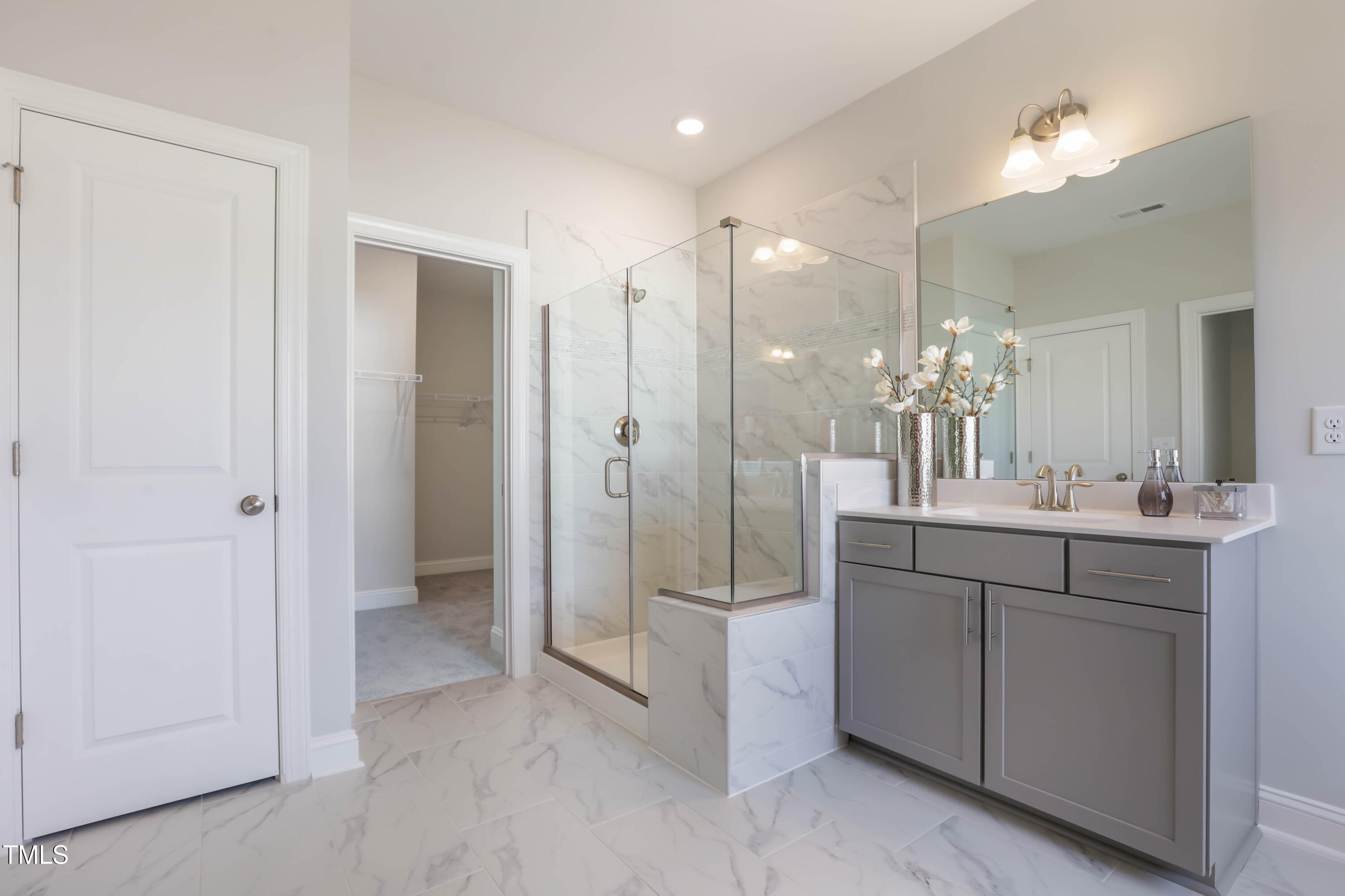 909 Jasper Mine Trail Raleigh, NC 27610 - Photo 20 of 39 a bathroom with a shower sink and mirror