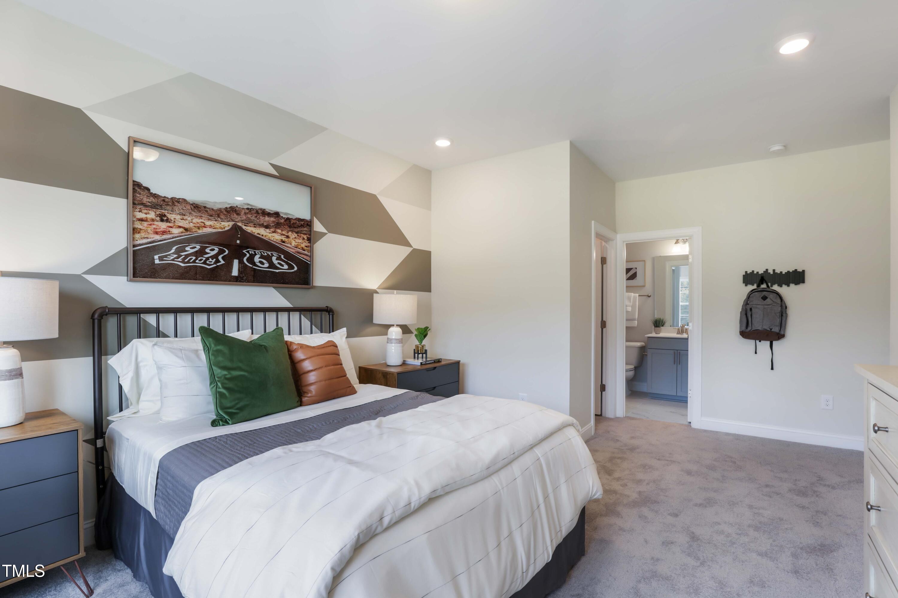 909 Jasper Mine Trail Raleigh, NC 27610 - Photo 29 of 39 a bedroom with a bed and a painting on the wall