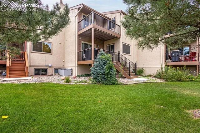 a view of a house with a yard and sitting area