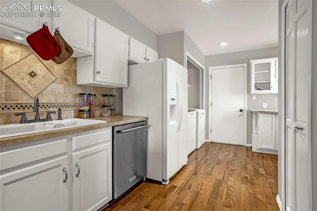 342 Mission Hill Way Colorado Springs, CO 80921 - Photo 11 of 37 a kitchen with a refrigerator and cabinets