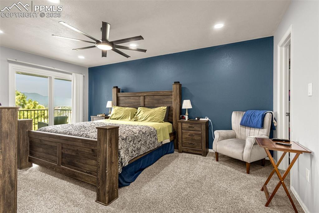 342 Mission Hill Way Colorado Springs, CO 80921 - Photo 27 of 37 a bedroom with a bed and a chandelier