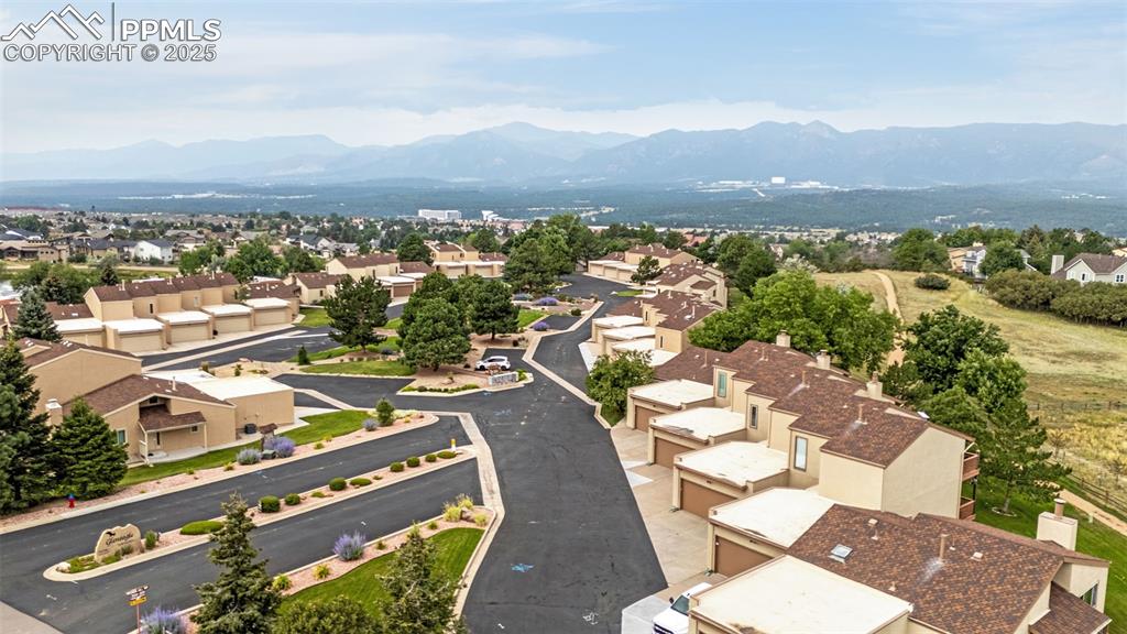 342 Mission Hill Way Colorado Springs, CO 80921 - Photo 33 of 37 an aerial view of a city with lots of residential buildings and mountain view in back