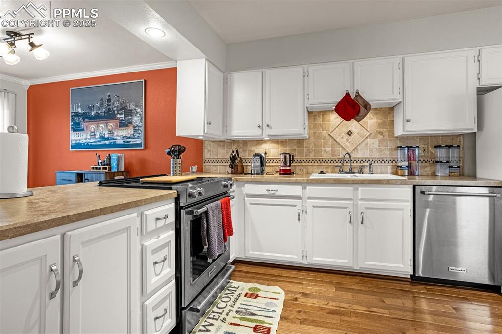 342 Mission Hill Way Colorado Springs, CO 80921 - Photo 10 of 37 a kitchen with stainless steel appliances granite countertop a stove a sink and a microwave