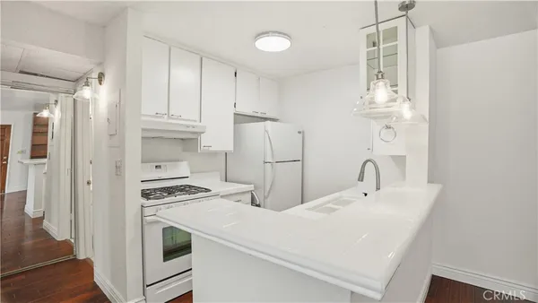 a kitchen with refrigerator and cabinets