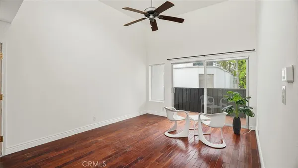 a room with wooden floor and potted plant