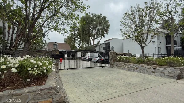 a view of house with yard and sitting area