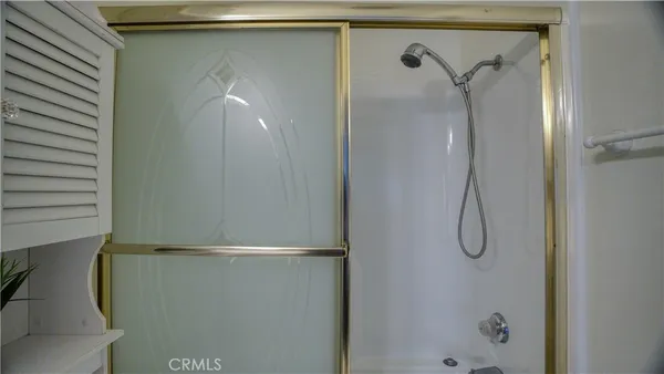 a bathroom with a glass shower door