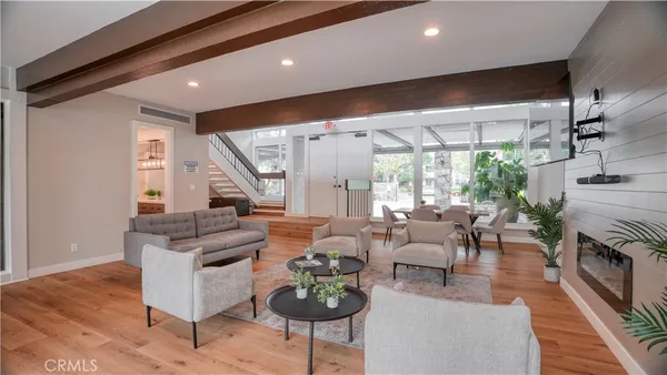 a living room with fireplace furniture and a large window