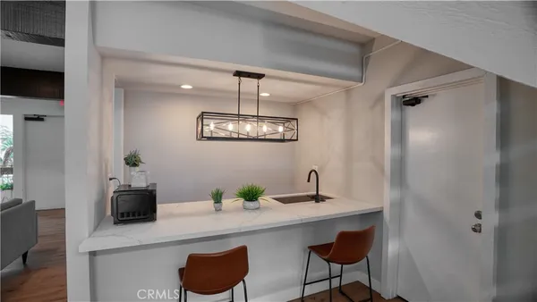 a dining room with table chairs and wooden floor