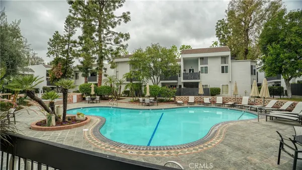 a view of a house with swimming pool and sitting area