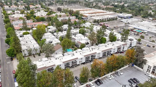 an aerial view of residential houses with outdoor space