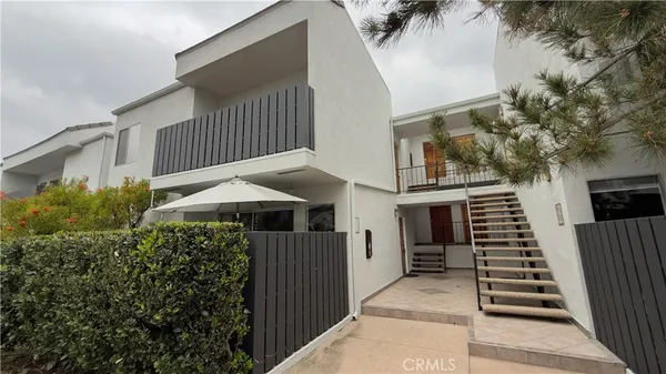 a balcony view with plants and wooden fence