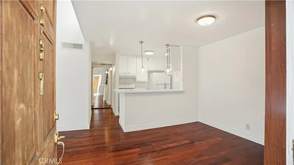 a view of kitchen and wooden floor