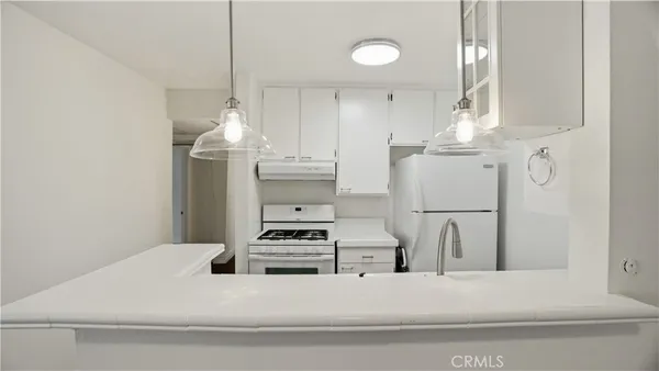 a kitchen with stainless steel appliances a refrigerator and a stove