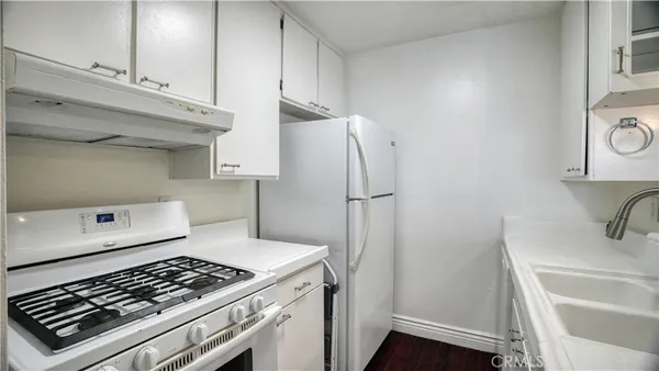 a kitchen with a stove and a refrigerator