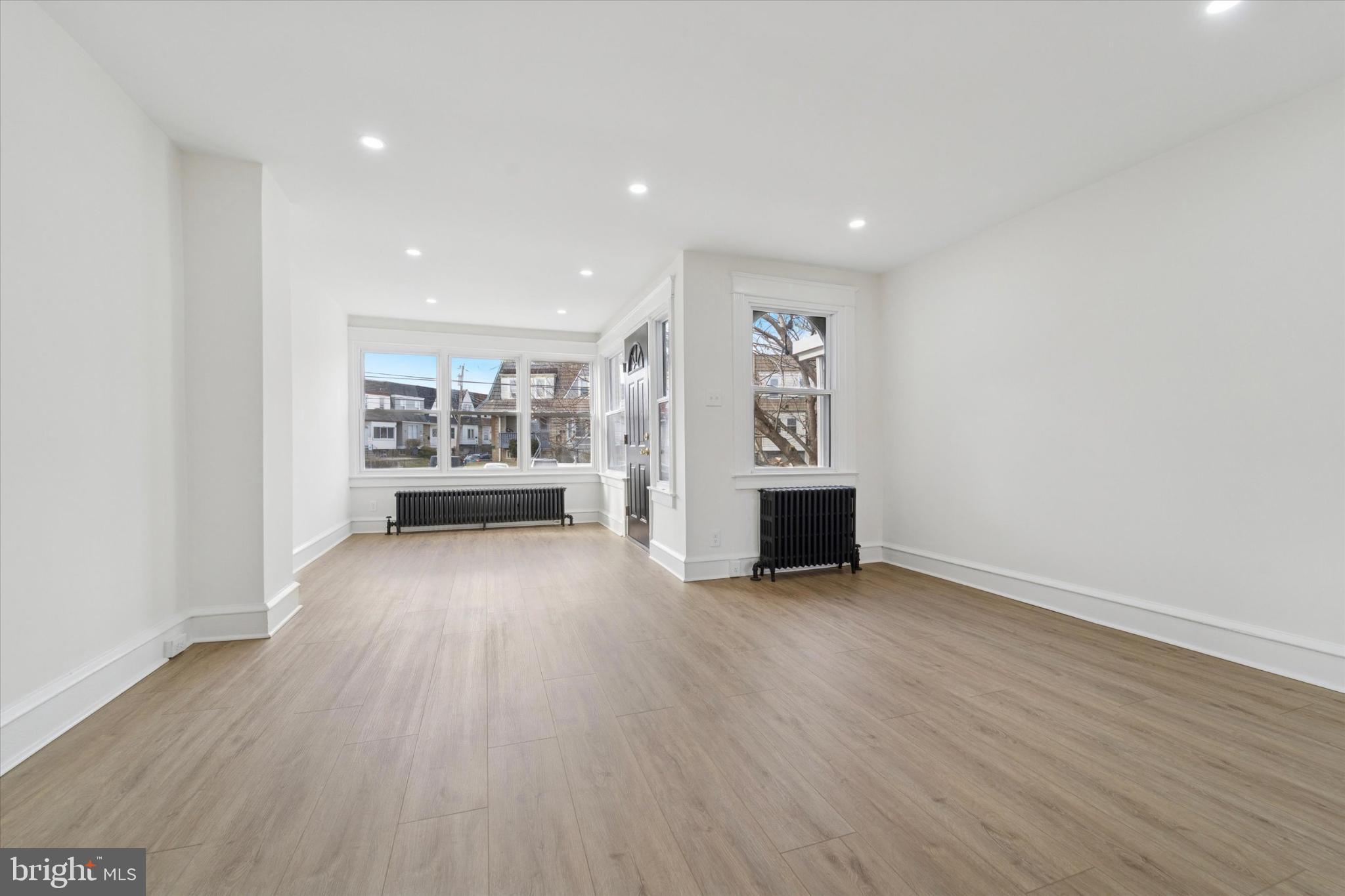 247 Coverly Road Lansdowne, PA 19050 - Photo 12 of 25 a view of a big room with wooden floor and windows