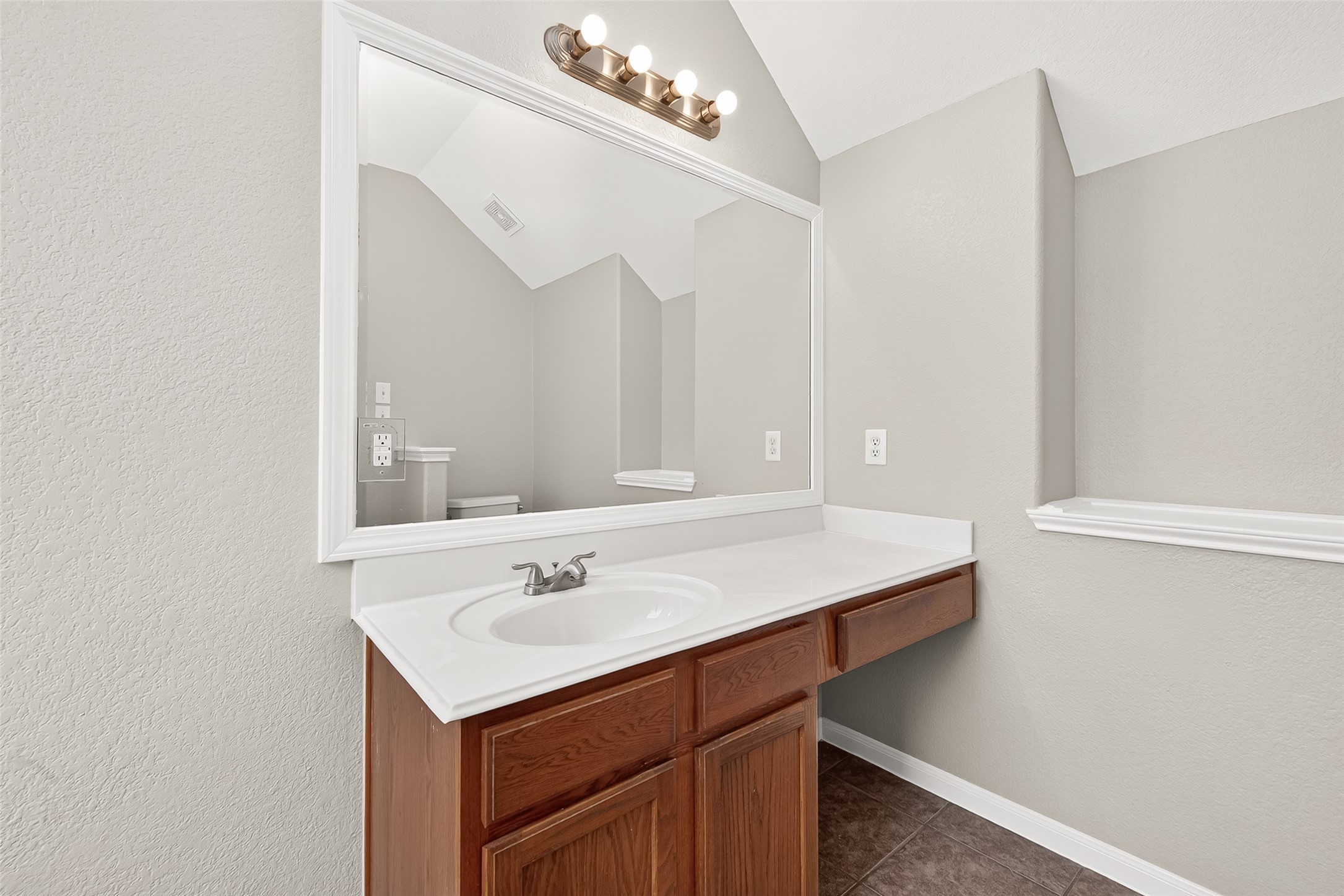 21327 Bella Flora Court Spring, TX 77379 - Photo 24 of 50 a bathroom with a sink vanity and a mirror