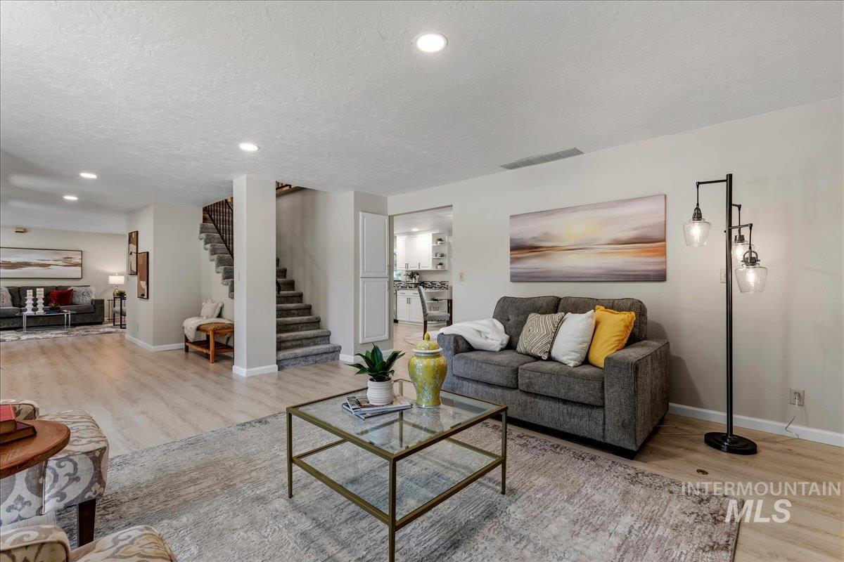 599 Pebble Beach Way Eagle, ID 83616 - Photo 17 of 44 Spacious living area featuring light wood-finish flooring, recessed lighting, and neutral wall tones