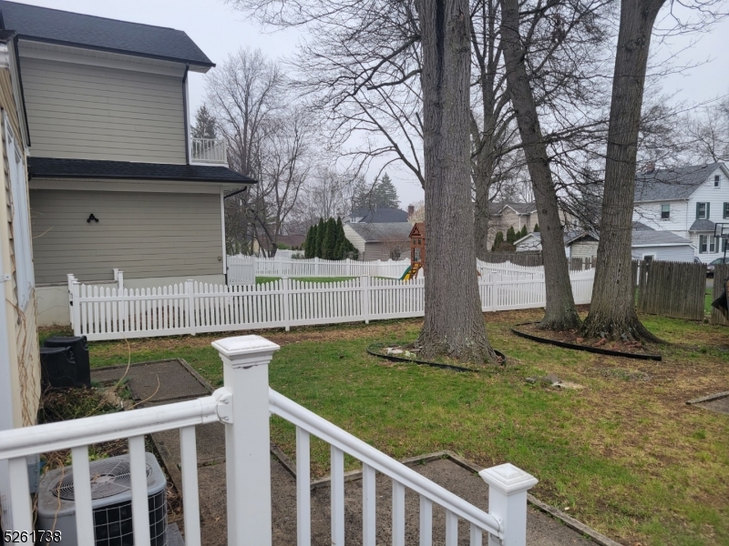20 Miele Place Summit, NJ 07901 - Photo 20 of 23 a view of a chair and table and yard with wooden fence