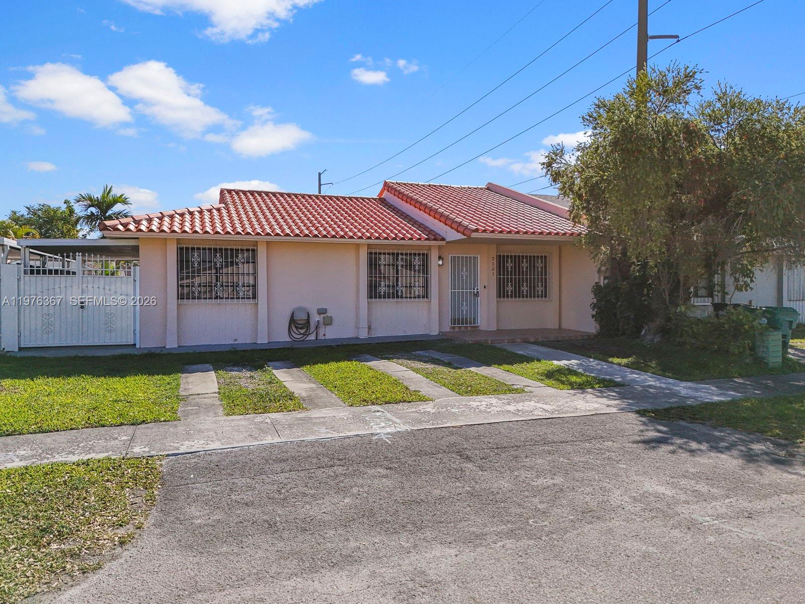 a view of pool with umbrella and wooden fence