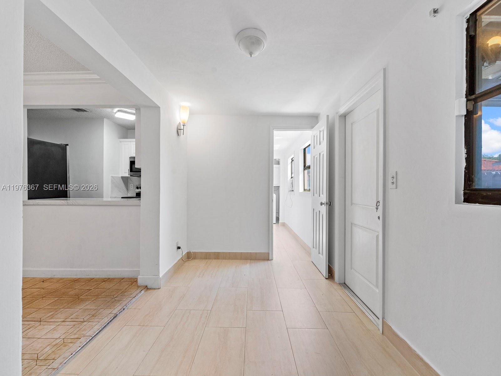 7121 Southwest 102nd Court Miami, FL 33173 - Photo 11 of 33 a view of a hallway with wooden floor and a living room