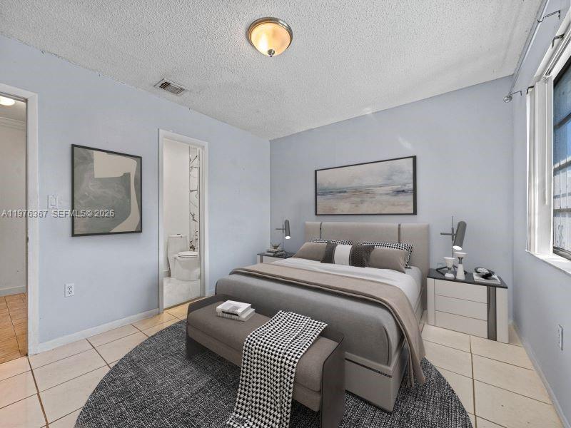 7121 Southwest 102nd Court Miami, FL 33173 - Photo 15 of 33 a bedroom with a bed and a couch