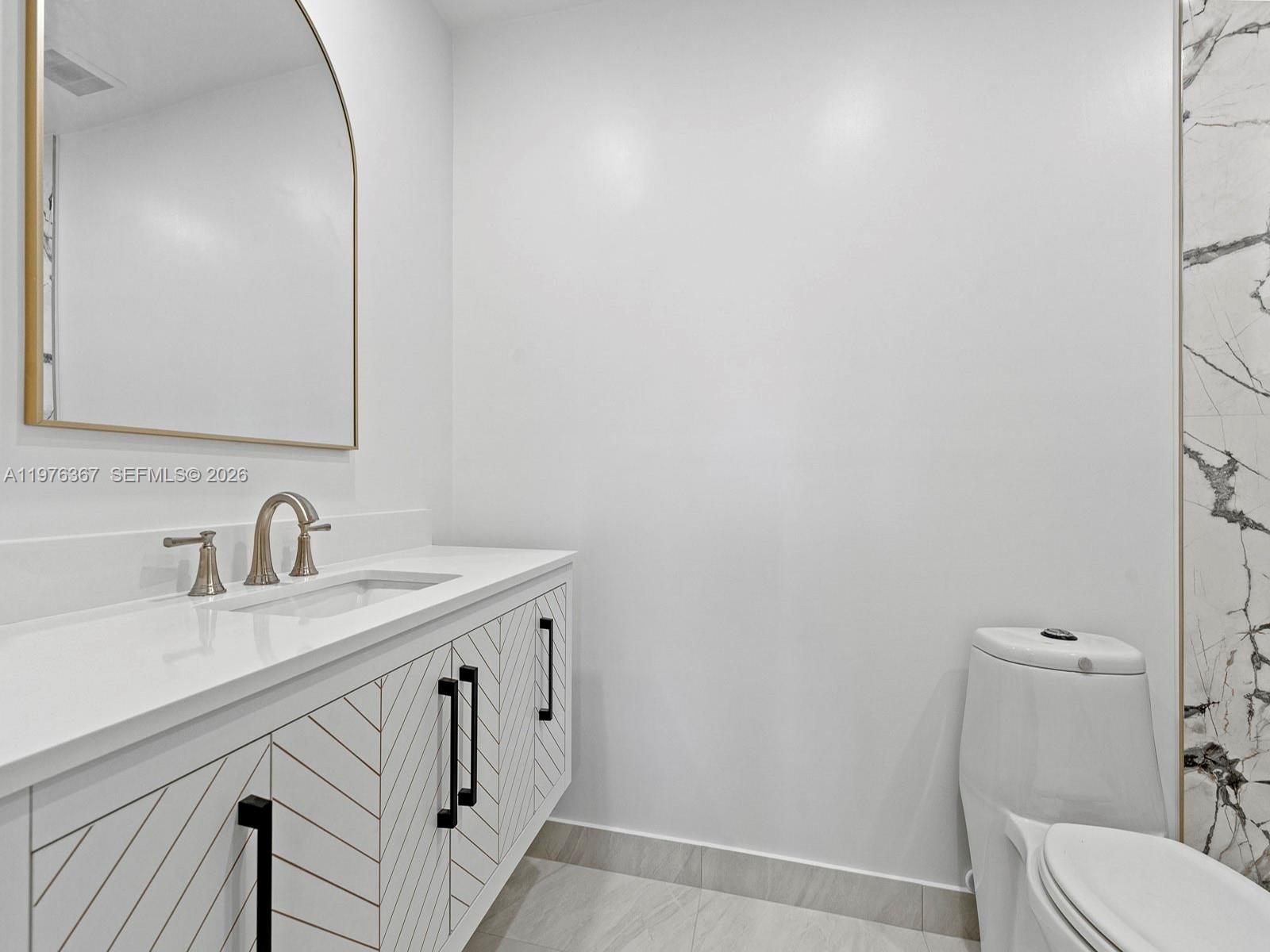 7121 Southwest 102nd Court Miami, FL 33173 - Photo 17 of 33 a bathroom with a sink a toilet and a mirror