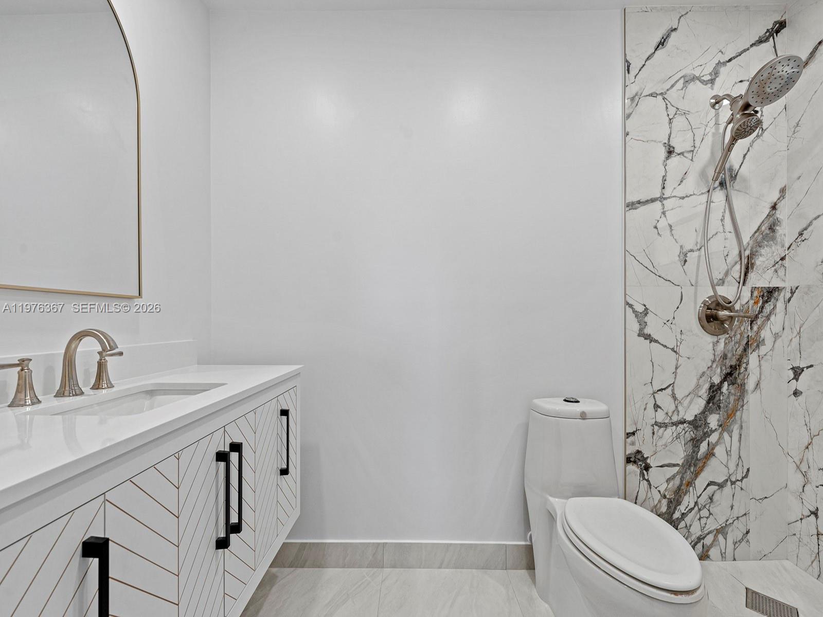 7121 Southwest 102nd Court Miami, FL 33173 - Photo 18 of 33 a bathroom with a granite countertop sink and a toilet