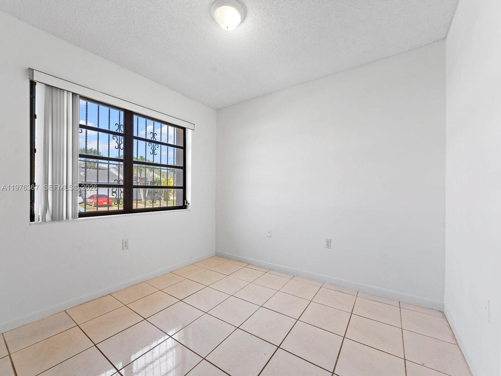 7121 Southwest 102nd Court Miami, FL 33173 - Photo 20 of 33 a view of an empty room and window